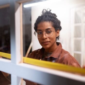 woman measuring wooden window
